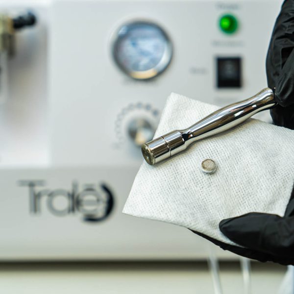 Tralē Brightening Serum bottle on linen